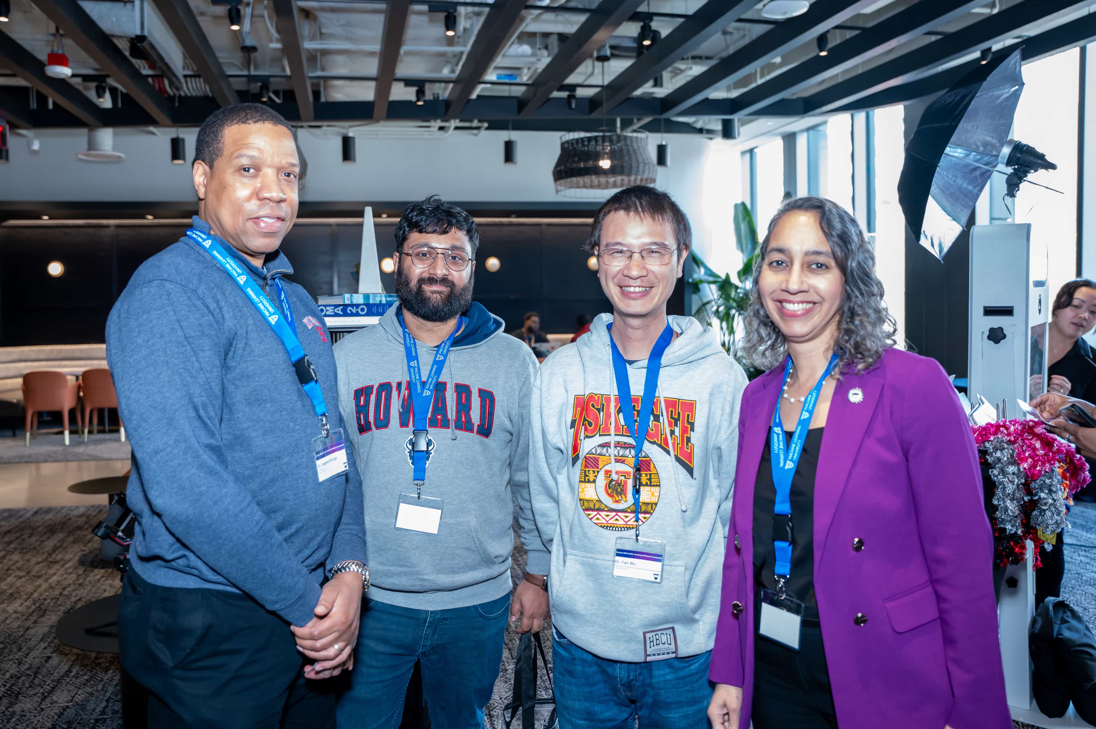 Photo of four faculty members standing side-by-side